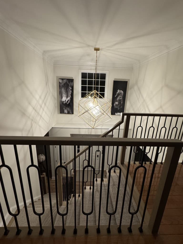Original vertical phone photo looking over an interior staircase